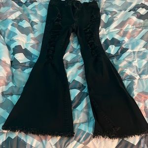 They are almost famous. They are bell bottoms. They are black.